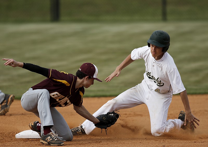 Silverdale runner Collin Lovell beats the tag by Grace shortstop Austin Henry at 2nd during their prep baseball game Tuesday, April 28, 2015, at Silverdale Baptist Academy in Chattanooga.