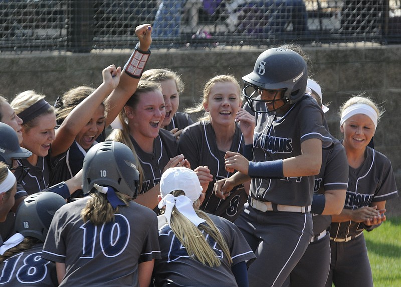 The entire Lady Trojans team welcomes Alexis Trimiar, right, to home plate following a two run homer in the bottom of the third inning against district power Ooltewah Wednesday, April 29, 2015, in Soddy-Daisy. The Region 6 A/AA Lady Trojans defeated the Lady Owls, 3-1.