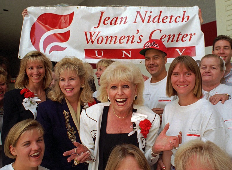 
              FILE - In this Sept. 9, 1995, file photo,  Jean Nidetch, center, founder of Weight Watchers International,  reacts with a group of workers from the Jean Nidetch Women's Center during a Jobs Fair on the campus of the University of Nevada at Las Vegas in Las Vegas. Nidetch, a New York housewife who tackled her own obesity problem, then shared her guiding principles with others in meetings that became known as Weight Watchers, the most widely known company of its kind, died Wednesday, April 29, 2015, at her home near Fort Lauderdale, Fla., her son David Nidetch said. She was 91. (AP Photo/Lennox McLendon, File)
            