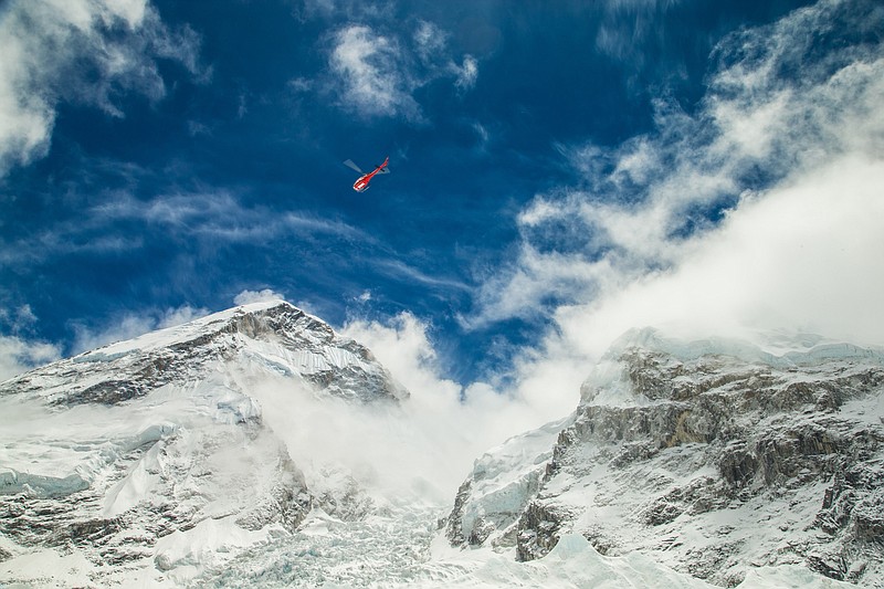 
              In this Sunday April 26, 2015, photo provided by 6summitschallenge.com, a helicopter prepares to rescue people at Everest Base Camp, Nepal. On Saturday, a large avalanche triggered by Nepal's massive earthquake slammed into a section of the Mount Everest mountaineering base camp, killing a number of people and left others unaccounted for. (Elia Saikaly/Courtesy of 6summitschallenge.com via AP) MANDATORY CREDIT
            