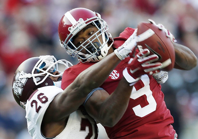 Alabama wide receiver Amari Cooper (9) catches a 50-yard pass against Mississippi State defensive back Kendrick Market (26) in their game in Tuscaloosa, Ala., on Nov. 15, 2014.