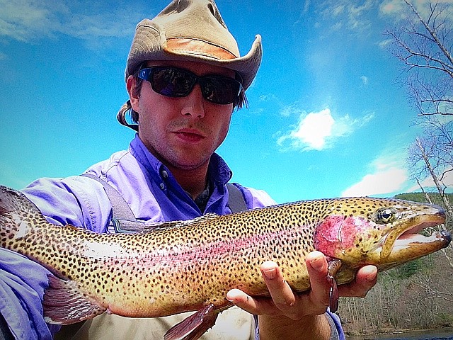 Kyle Ogle holds a  rainbow trout that he caught March 21 on the Hiwassee River.