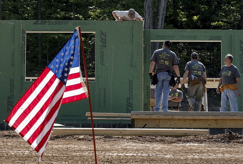 Volunteers secure an exterior wall while constructing a new home for wounded U.S. Army veteran Jason Smith on Thursday, April 30, 2015, in Ringgold, Ga. 