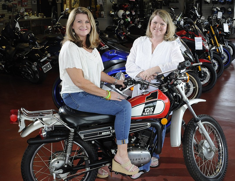 Sisters Gina Tyler, left, and Kristie Haun are general managers of Ed's Cycles in Cleveland. Tyler started riding on a motorcycle similar to this 1974 Yamaha when she was four-years-old. Haun began riding later in life.