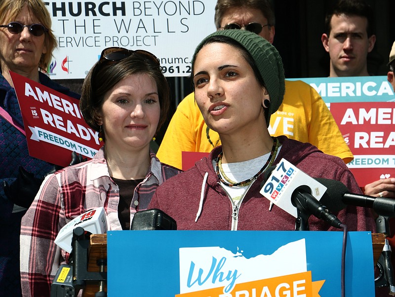 Kelly Noe, left, listens to her partner Kelly McCraken speak to supporters during a send-off event in support of plaintiffs in gay marriage cases that will be argued April 28before the U.S. Supreme Court on the steps of City Hall in downtown Cincinnati in this April 24, 2015, file photo. 