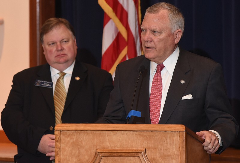 State Senator Jeff Mullis, left, listens as Georgia Governor Nathan Deal speaks at the Walker County Civic Center on Wednesday, May 1,  2015, in Rock Spring, Ga., before signing legislation to increase the punishment for people who kill a police dog. The new legislation is known as Tanja's Law, in honor of Walker County Deputy Donnie Brown's dog, killed by a shotgun blast while police were conducting a raid. 