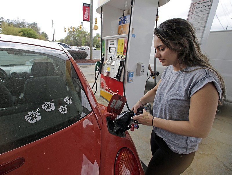 Lucy Perez  pumps gas at a station in this file photo.