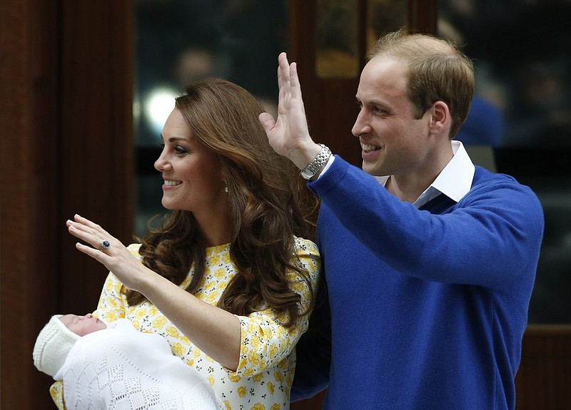 Britain's Prince William, right, and Kate, Duchess of Cambridge, pose for the media with their newborn daughter outside St. Mary's Hospital's exclusive Lindo Wing, London, Saturday, May 2, 2015. The Duchess gave birth to the Princess on Saturday morning.