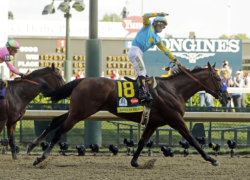 Victor Espinoza rides American Pharoah to victory in the 141st running of the Kentucky Derby horse race at Churchill Downs on Saturday, May 2, 2015, in Louisville, Ky. 