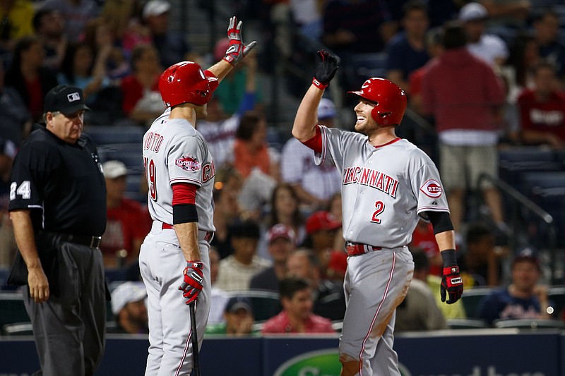 Cincinnati Reds shortstop Zack Cozart celebrates with first baseman Joey Votto after Cozart hit a two-run home run in the 9th inning of their game against the Atlanta Braves Saturday, May 2, 2015 in Atlanta. 