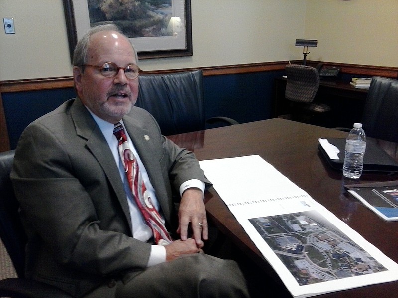 County commissioner Tim Boyd looks over architectural drawings for a proposed vocational high school he'd like to see built on Chattanooga State Community College's campus in this file photo.