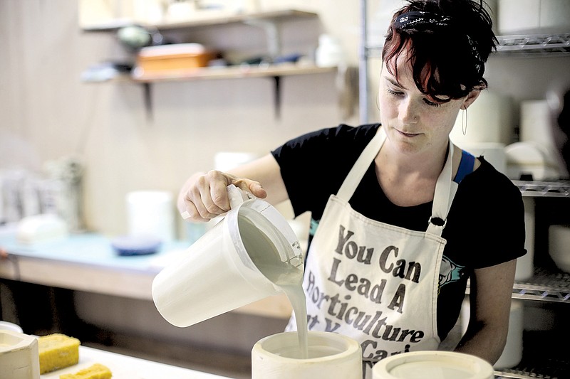 Jessie Bean Bailey of Bean and Bailey Ceramics pours slip into a mold in her Highland Park studio in Chattanooga.
