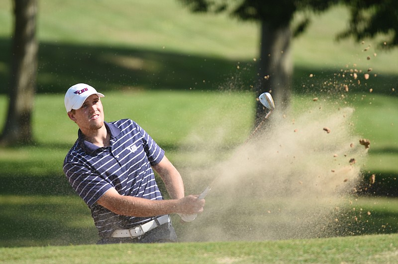 Taylor Davis hits a shot out of a bunker next to the 18th green in the final round of the Cleveland Invitational golf tournament Sunday, May 3,  2015, in Cleveland, Tenn.