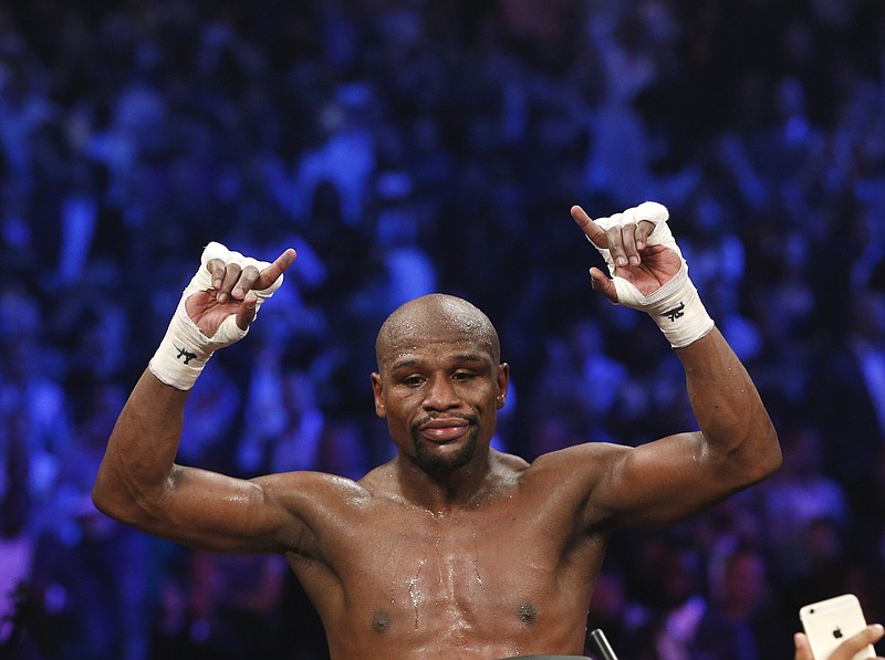 Floyd Mayweather Jr., celebrates his unanimous decision victory over Manny Pacquiao, from the Philippines, at the finish of their welterweight title fight on Saturday, May 2, 2015 in Las Vegas. 