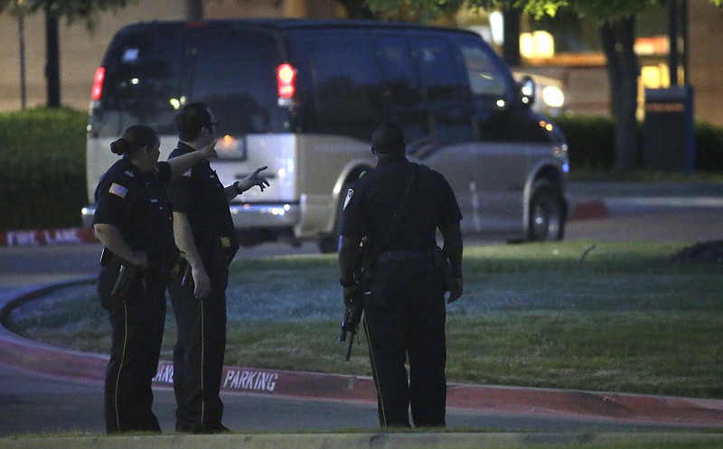 Police officers stands guard at a parking lot near the Curtis Culwell Center where a provocative contest for cartoon depictions of the Prophet Muhammad was held Sunday, May 3, 2015, in Garland, Texas.