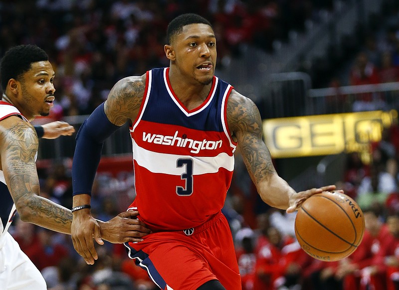 Washington Wizards guard Bradley Beal (3) drives past Atlanta Hawks guard Kent Bazemore (24) in their second-round basketball payoff series game, Sunday, May 3, 2015, in Atlanta. Washington won 104-98. 