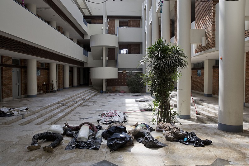 
              Bodies of people who died a week ago during the earthquake lay alongside blocks of ice in the lobby of a building adjacent to a hospital morgue, where relatives can identify them, Kathmandu, Nepal, Sunday, May 3, 2015. The Kathmandu morgue has been struggling to keep up with the relentless flow of corpses in the aftermath of the April 25 earthquake that left more than a thousand dead just in the capital. (AP Photo/Bernat Amangue)
            