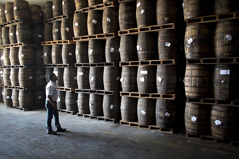 
              In this Thursday, March 26, 2015 photo, Jhorgen Romero, Head of Processing and Aging at Santa Teresa looks at the barrels filled with rum at the Santa Teresa rum factory in La Victoria, Aragua State, Venezuela. The fall in international oil prices and the consequent shortage of foreign exchange seriously affects Venezuela's economy, heavily dependent on imports, but for some domestic producers like rum manufacturers it's an opportunity to increase production and meet growing sales inside and outside the country. (AP Photo/Ariana Cubillos)
            