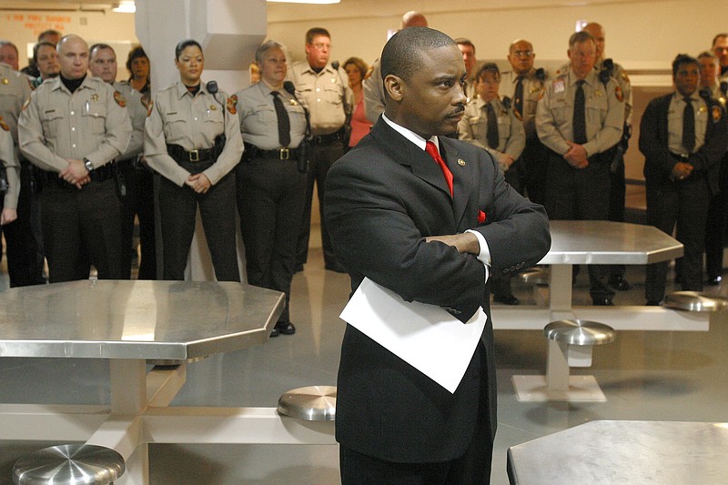 In this Thursday, Jan. 13, 2005, file photo, Newly sworn-in Clayton County Sheriff Victor Hill, foreground, stands with arms folded after speaking to his deputies in Jonesboro, Ga.