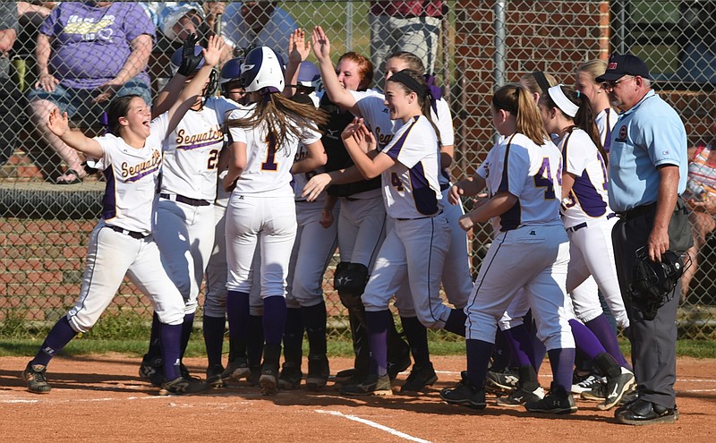 Sequatchie County's Allyson Davenport is greeted by teammates after hitting a home run on the way to a 9-4 victory over Grundy County in the District 7-AA softball championship game Monday, May 4, 2015, in Dunlap, Tenn.