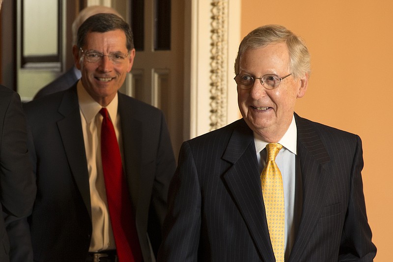 
              Senate Majority Leader Mitch McConnell of Ky., right, followed by Sen. John Barrasso, R-Wyo., leaves a GOP luncheon on Capitol Hill in Washington, Tuesday, May 5, 2015.  (AP Photo/Brett Carlsen)
            