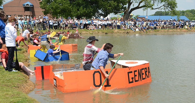 David Zumbrun, left, and Calvin Conn begin paddling as they and other Boyd-Buchanan students participate in a race during the 19th annual Physics Boat Day on Wednesday, May 6, 2015, in Chattanooga. 