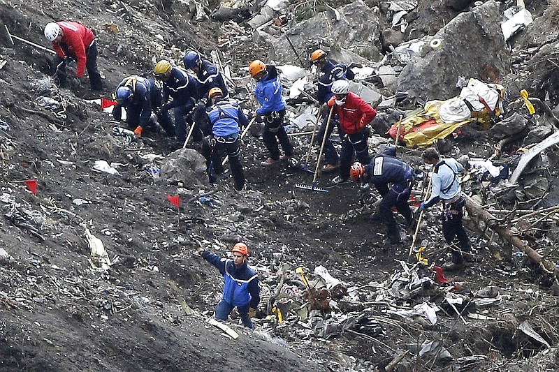 
              FILE - In this March 26, 2015 file photo, rescue workers work on debris of the Germanwings jet at the crash site near Seyne-les-Alpes, France. The co-pilot of Germanwings Flight 4525 tried a controlled descent on the previous flight that morning to Barcelona before the plane crashed into a mountainside in March on its way back to Germany, French air accident investigators said in a new report released Wednesday May, 6, 2015. (AP Photo/Laurent Cipriani, File)
            