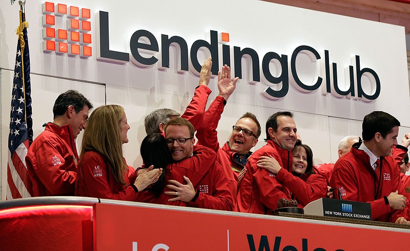 
              FILE - In this Dec. 11, 2014 file photo, Renaud Laplanche, third from right, Founder & CEO of Lending Club, embraces company CFO Carrie Dolan during opening bell ceremonies of the New York Stock Exchange, to mark Lending Club's IPO. Shares of Lending Club advanced 3 percent Wednesday, May 6, 2015, after the company reported better-than-expected results and upped its full-year outlook as more consumers discover peer-to-peer lending as an cheaper alternative to a traditional bank. (AP Photo/Richard Drew, File)
            
