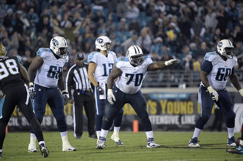 Tennessee Titans offensive linemen Byron Stingily (68), Chance Warmack (70) and Chris Spencer (60) set up at the line of scrimmage in this Dec. 18, 2014, file photo.