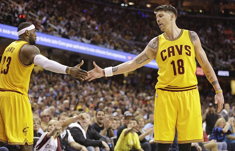 Cleveland Cavaliers forward LeBron James (23) slaps hands with Cleveland Cavaliers guard Mike Miller (18) during a break in play against the Chicago Bulls on May 6, 2015, in Cleveland, Ohio.