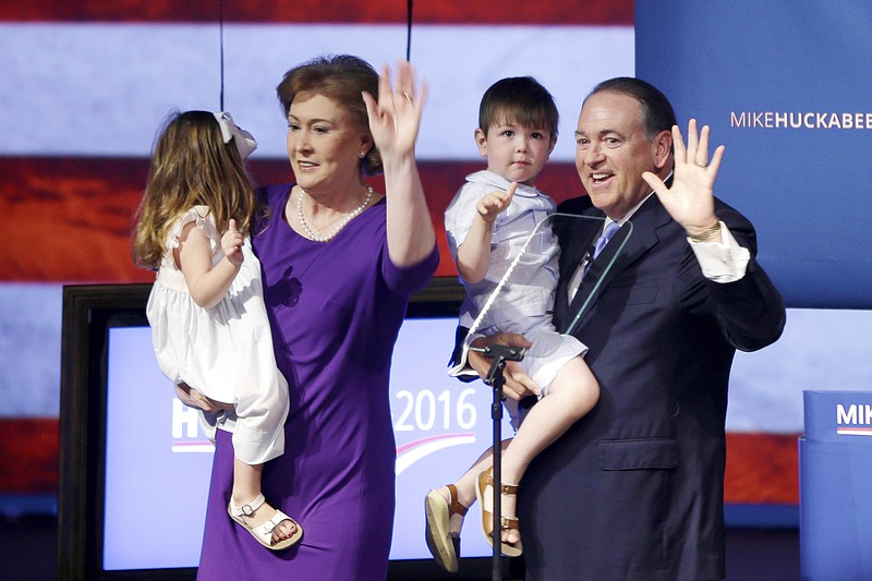 Former Arkansas Gov. Mike Huckabee, right, holds he grandson Chandler, as his wife Janet holds granddaughter Scarlett, Tuesday, May 5, 2015, in Hope, Ark., after announcing that he is running for the Republican presidential nomination.