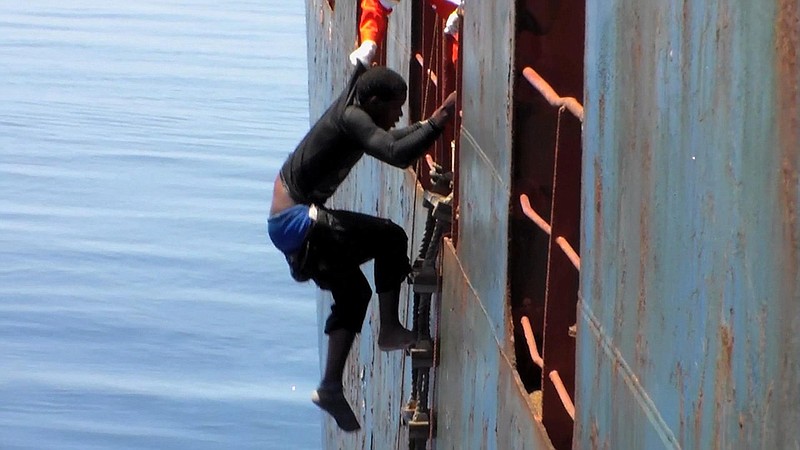 Dramatic footage emerged Tuesday May 5, 2015, filmed by a crew member, showing a Mediterranean Sea rescue of migrants on a sinking rubber boat desperately clambering up ropes and a ladder from the cargo ship Zeran that came to their aid on May 3, 2015, in the sea between Libya and Sicily.