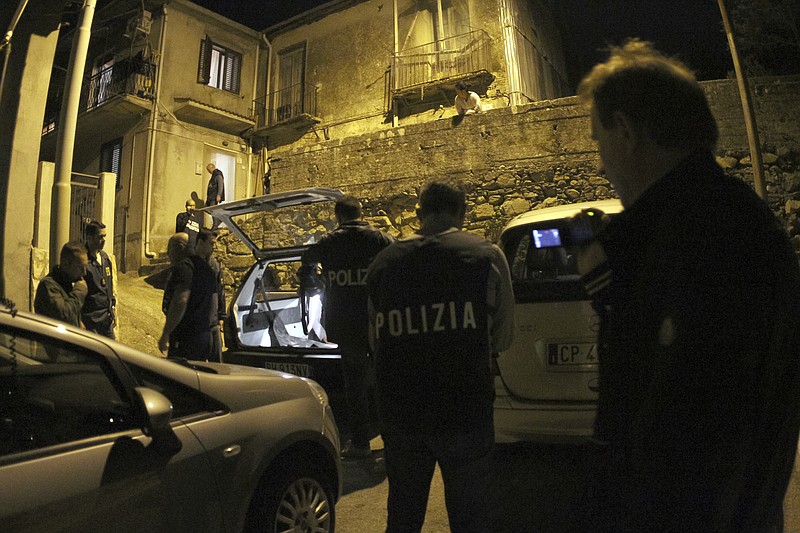 
              Police officers stand outside a suspect's house during an operation conducted with U.S. FBI agents, in Sinopoli, southern Italy, early Thursday morning, May 7, 2015. Italian police said that in operations conducted with U.S. FBI agents they have dismantled a major drug trafficking ring whose base was a restaurant-pizzeria in New York City. At least 15 suspects have been detained by early Thursday, including three in the United States connected with the eatery in the city's Queens borough. Investigators say the crackdown further demonstrates that the 'ndrangheta, an organized crime syndicate rooted in Calabria in the toe of the Italian peninsula, have forged ever stronger ties with U.S.-based mobsters. (AP Photo/Adriana Sapone)
            
