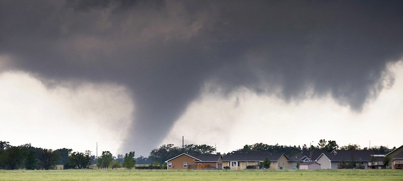 
              A tornado passes near Halstead, Kan., Wednesday, May 6, 2015. A swath of the Great Plains is under a tornado watch Wednesday, including parts of North Texas, Oklahoma, Kansas and Nebraska. (Travis Heying/The Wichita Eagle via AP)
            