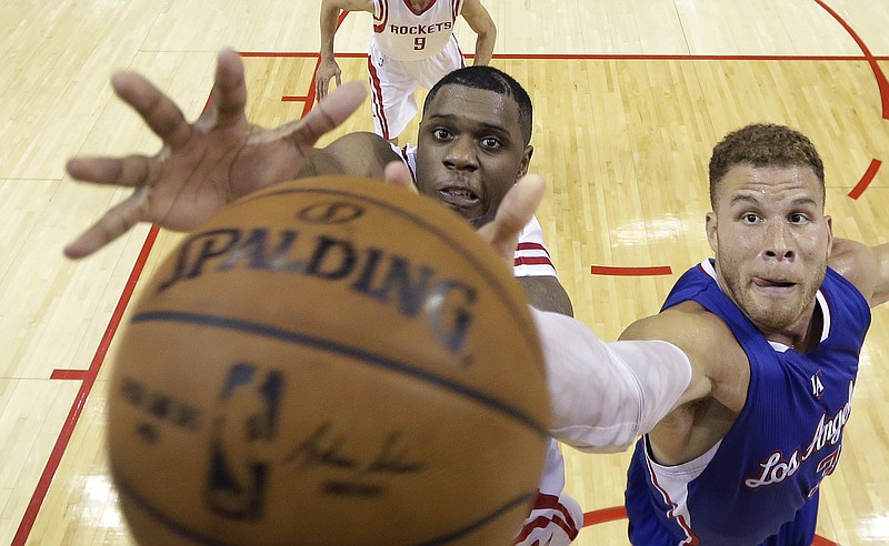 Houston Rockets' Terrence Jones, left, and Los Angeles Clippers' Blake Griffin reach for a rebound during their Game 2 in a second-round NBA basketball playoff series on Wednesday, May 6, 2015, in Houston.