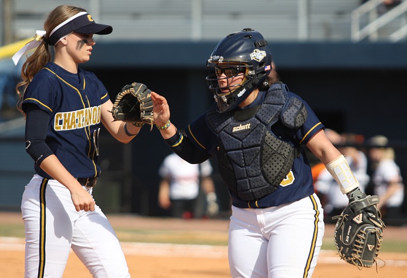 UTC's Alyssa Taylor, left, and Anyssa Robles celebrate after ending the top of an inning in this Feb. 23, 2014, file photo.