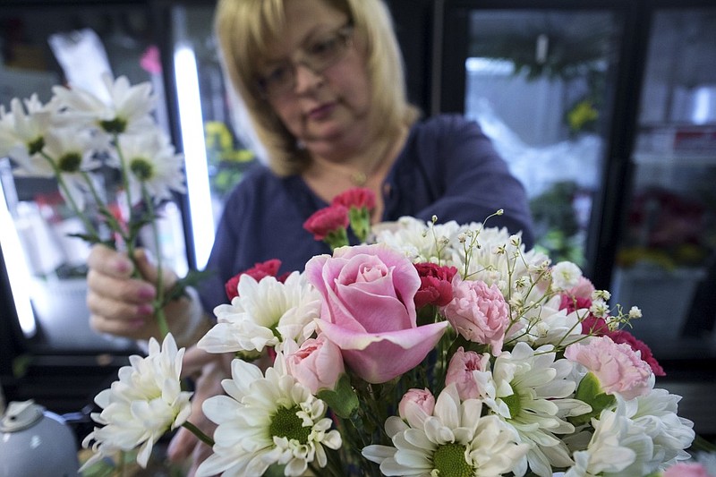 Owner Samantha Dawson puts together an arrangement for Mother's Day on Friday at Blossom Designs in Chattanooga.