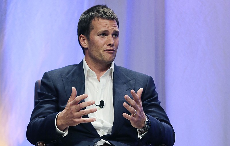 
              New England Patriots quarterback Tom Brady gestures during an event at Salem State University in Salem, Mass., Thursday, May 7, 2015. An NFL investigation has found that New England Patriots employees likely deflated footballs and that quarterback Tom Brady was "at least generally aware" of the rules violations. The 243-page report released Wednesday, May 6, 2015, said league investigators found no evidence that coach Bill Belichick and team management knew of the practice. (AP Photo/Charles Krupa, Pool)
            