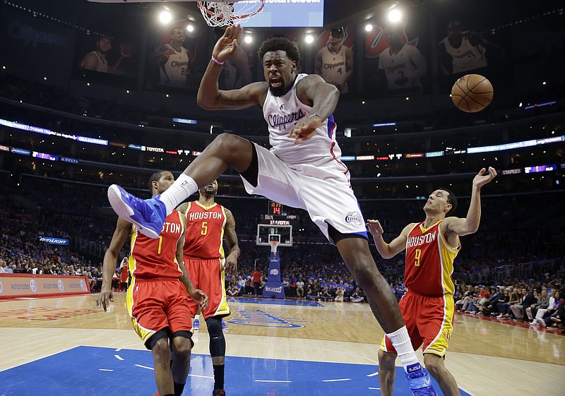 Los Angeles Clippers center DeAndre Jordan, second from right, celebrates after dunking as Houston Rockets forward Trevor Ariza, left, Josh Smith, second from left, and guard Pablo Prigioni, of Argentina, watch during their Game 4 of a second-round NBA basketball playoff series, Sunday, May 10, 2015, in Los Angeles.