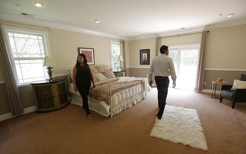 
              In this May 6, 2015 photo, realtor Stephan Marshall, right, walks with potential buyer Sasha Martinez at a home for sale on Perez Drive in Pacifica, Calif. Among the toughest markets for homebuyers are San Jose, San Francisco and Los Angeles, as well as Seattle, Denver, Dallas-Fort Worth, Texas, Nashville and Boston, according to Zillow. In those areas, homes are selling an average of 48 days faster than properties in markets where buyers have the edge, according to Zillow. (AP Photo/Jeff Chiu)
            