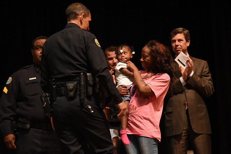 Chief Fred Fletcher, left, recognizes little Zoey Duncan after presenting Life Saving Awards to Chattanooga police officers Brandon Herring, Clayton Holmes and Sgt. Darrell Turner on Tuesday at Chattanooga State Community College. Zoey's mother, Bianca Horton, holds her as Mayor Andy Berke, right, applauds.