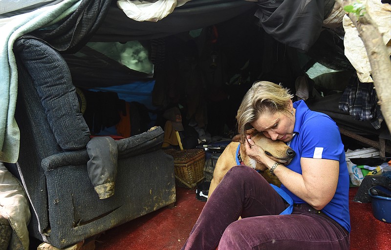 Veterinarian Angelika Lingl snuggles Golden at his owner's campsite in Brainerd.
