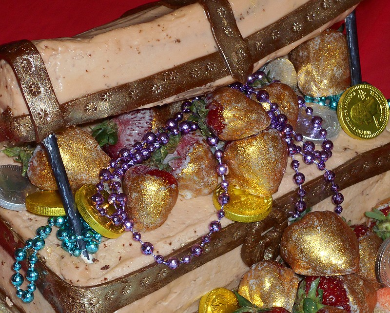 Donna Belcher's Strawberry Treasure Ice Cream Cake won Overall Champion at the 68th Tennessee Strawberry Festival's pie and cake contest in Dayton, Tenn. The chest's raised lid revealed candy gold doubloons, strands of Mardi Gras beads and strawberries dipped in white chocolate then painted with edible gold dust.