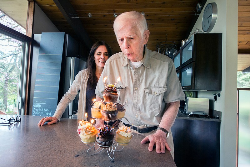 
              In this Monday April 27, 2015 photo provided by West Virginia University, 94-year-old Anthony Brutto blows out the candles on a birthday cake as his daughter, Lisa Bridges, looks on in his home in Morgantown, W. Va.  Brutto will be one of the oldest graduates in the history of West Virginia University when he receives his diploma Sunday, May 17.  (Brian Persinger/West Virginia University via AP)
            