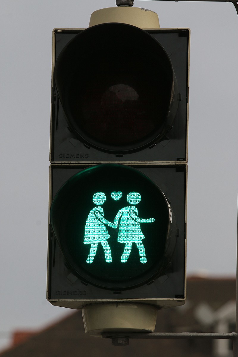 
              A street light with a same gender pair is pictured in dowtown Vienna, Austria, May 12, 2015. These lights were set up by city officials until June, just in time for the annual Life Ball, where celebrities will rub shoulders with party-goers dressed in little more than body paint and cross-dressers in wild costumes at the charity event supporting AIDS research. (AP Photo/Ronald Zak)
            