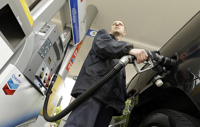 James Lewis pumps gas at a station in this file photo.