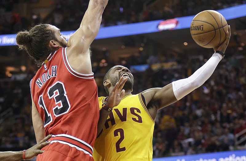 Cleveland Cavaliers guard Kyrie Irving (2) shoots in front of Chicago Bulls center Joakim Noah (13) during the second half of Game 5 in a second-round NBA basketball playoff series Tuesday, May 12, 2015, in Cleveland.