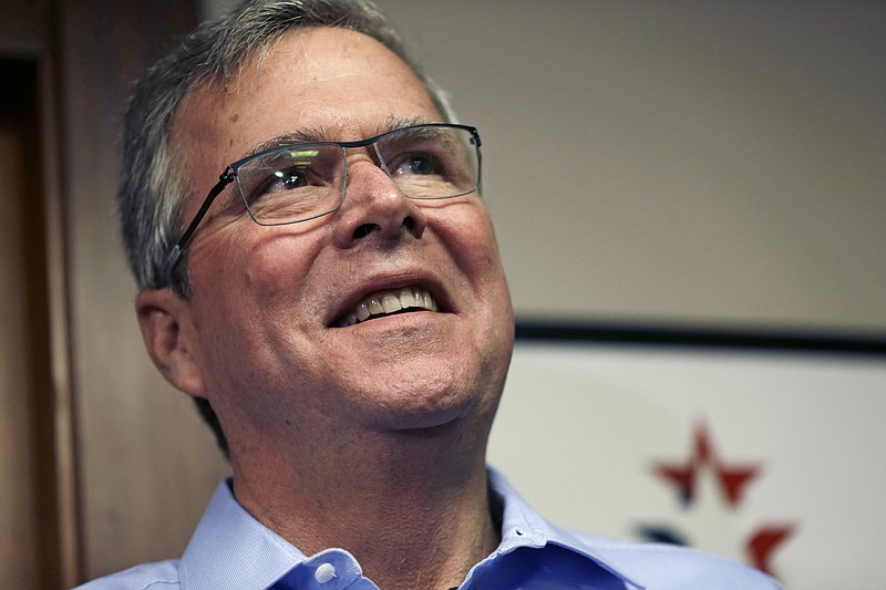 In this April 17, 2015, photo, former Florida Gov. Jeb Bush smiles while speaking to reporters after a "Politics and Eggs" event, a breakfast fixture for 2016 presidential prospects at Saint Anselm College in Manchester, N.H.
