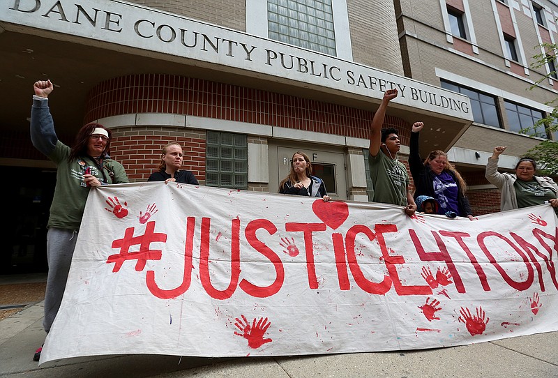 Supporters of Tony Robinson gather outside the Dane County Public Safety Building in Madison, Wis., Tuesday, May 12, 2015, after Dane County District Attorney Ismael Ozanne cleared Madison officer Matt Kenny of any wrongdoing in the fatal shooting of an unarmed 19-year-old in March 2015.