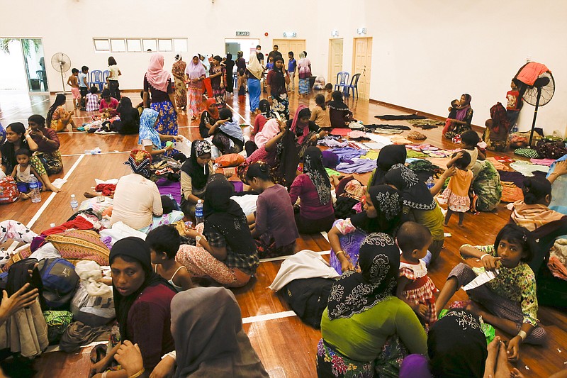 Migrants rest at a temporary immigration detention center in Langkawi, Malaysia, on Tuesday, May 12, 2015.